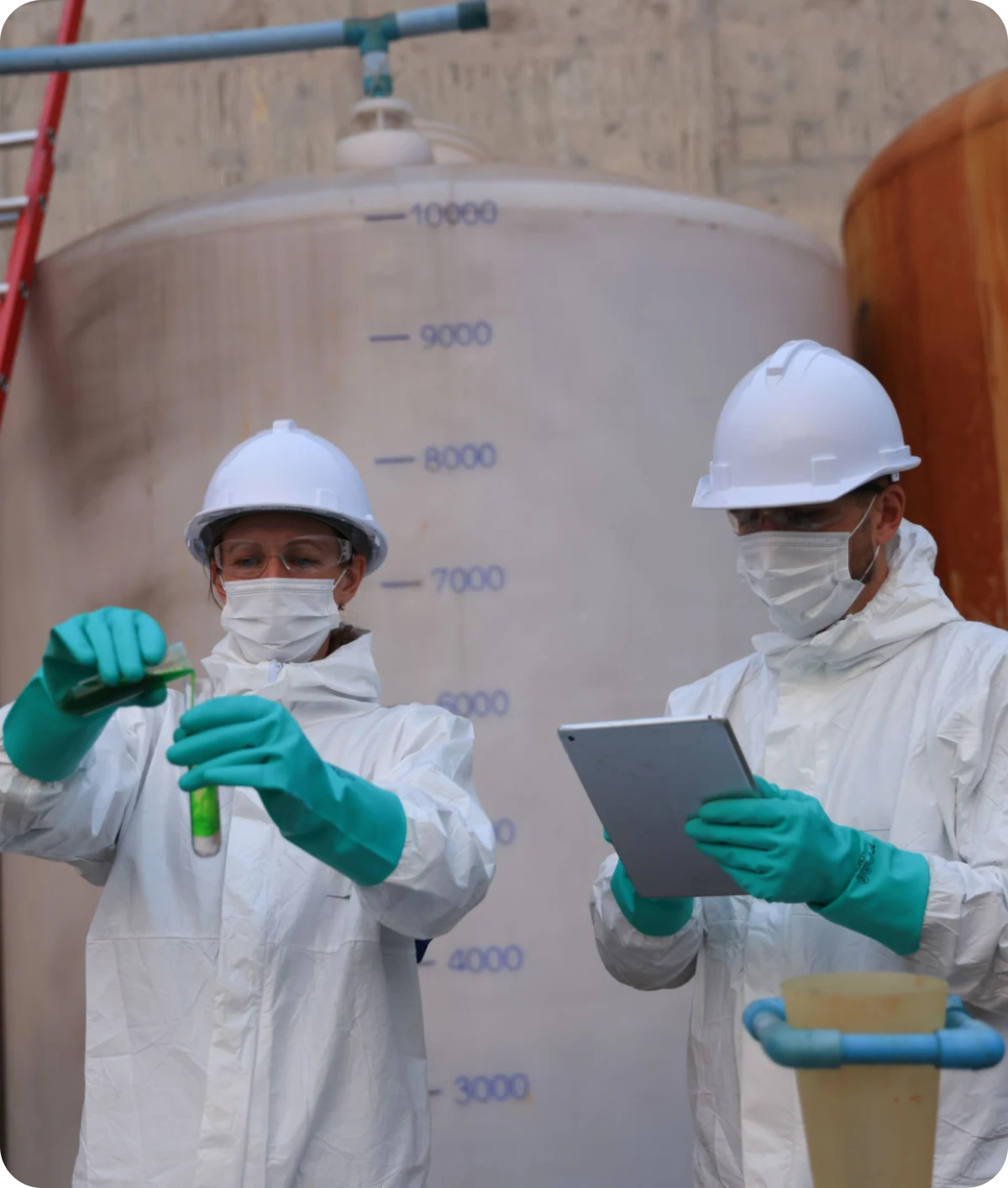 Scientists in protective gear conducting experiment.