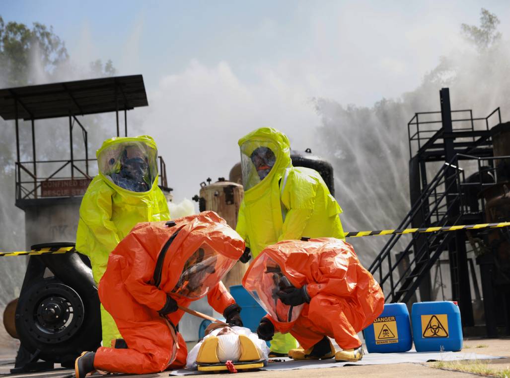 People in hazmat suits during emergency drill.