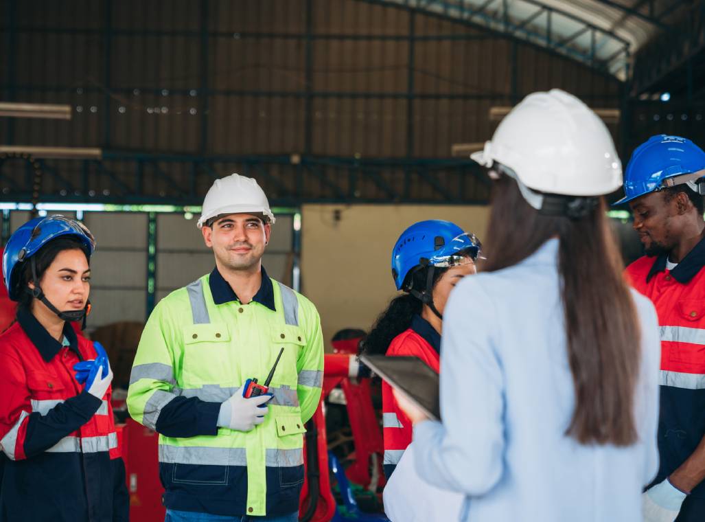 Workers in safety gear during briefing session.